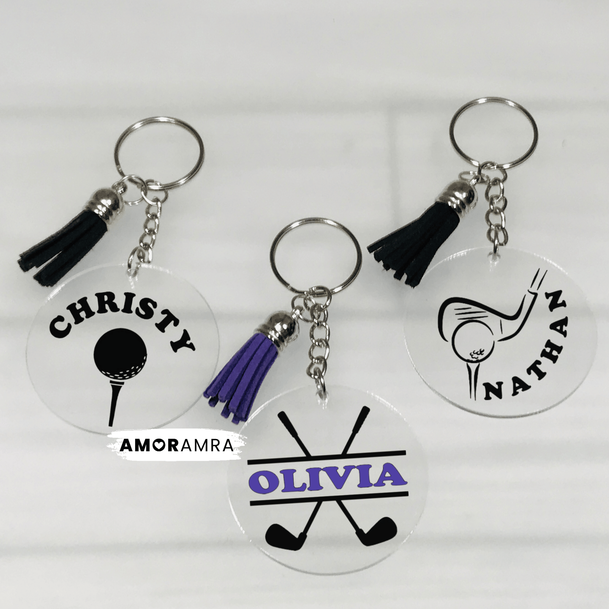 Three personalized keychains with names and golf-themed designs on a white background.