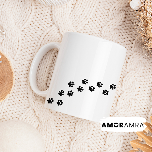 White mug with black paw prints