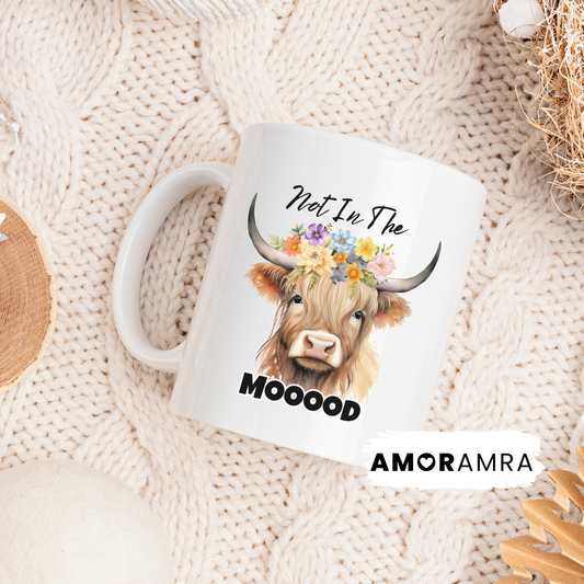 white Mug with a highland cow illustration and text 'Not In The MOOOD'
