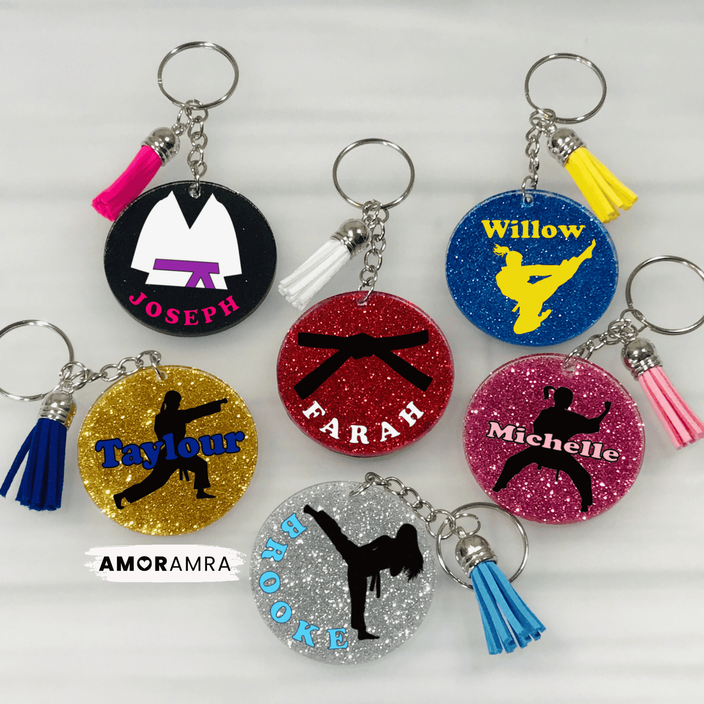 Collection of personalized keychains with names and martial arts-themed designs. Personalized Glitter Martial Arts Keychain. May include: round, glitter-covered keychains with different designs. Each keychain has a silver chain and a tassel. Personalized Martial Arts Keychain, Karate Keychain, Karate Gift, Martial Arts Belt, Judo Keychain, Taekwondo Gift, Jiu Jitsu Keychain