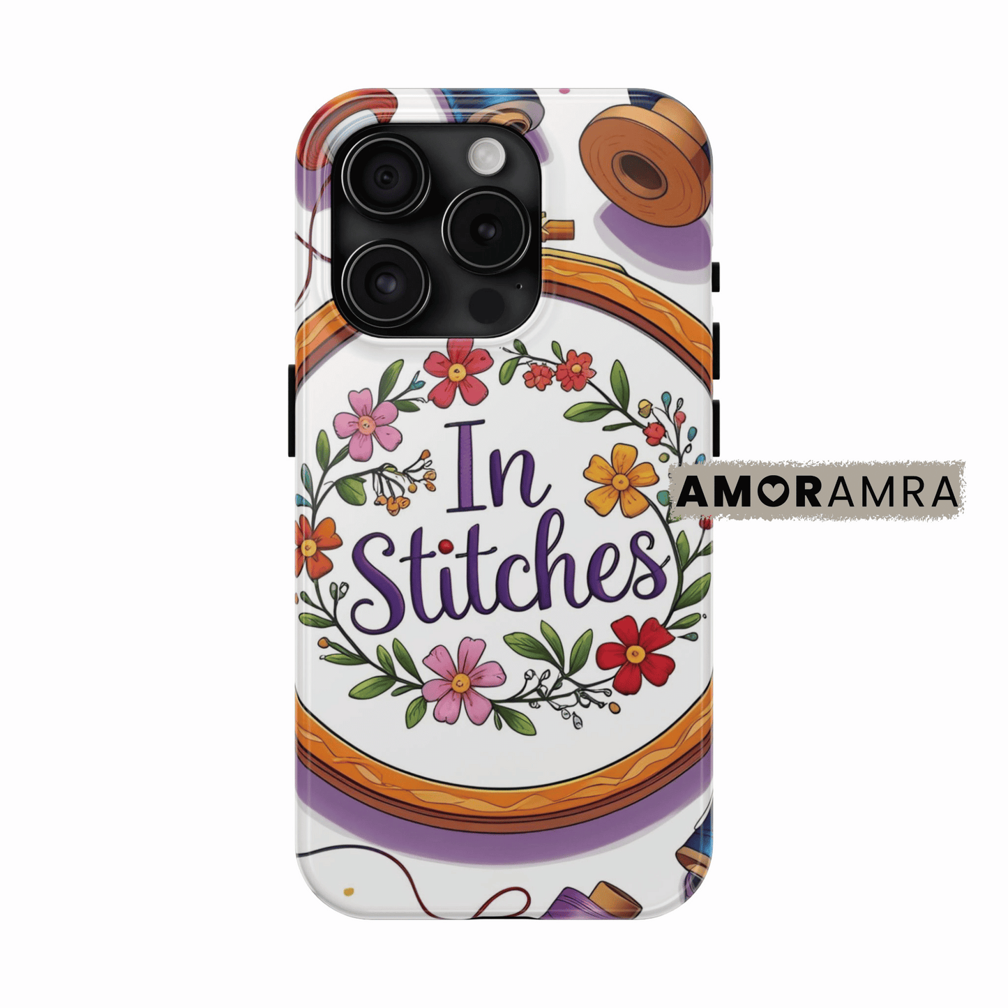 Phone case with 'In Stitches' design and floral elements on a white background,Crafted for embroidery lovers, this phone case stitches together charm and creativity. Featuring a delicate embroidery hoop with floral threads and vibrant colors, it’s perfect for crafters, sewists, and fiber artists who are always "in stitches."