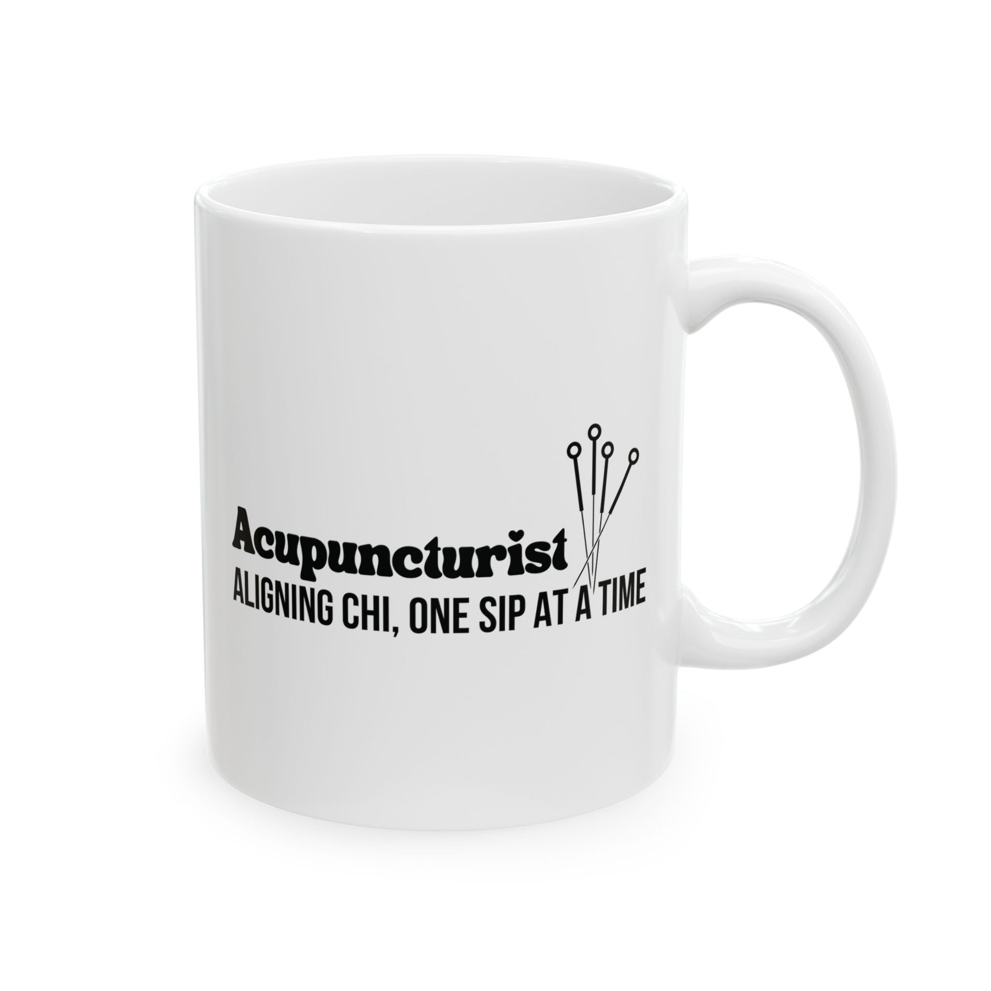 White mug with black text and acupuncture needle design on a white background