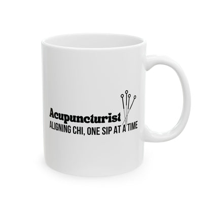 White mug with black text and acupuncture needle design on a white background