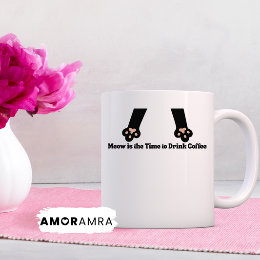 White mug with 'Meow is the Time to Drink Coffee' text and paw prints, 