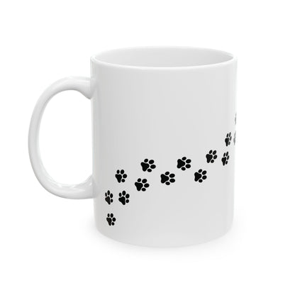 White mug with black paw print design on a white background