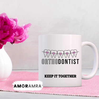 White mug with 'Orthodontist Keep It Together' with pink braces design