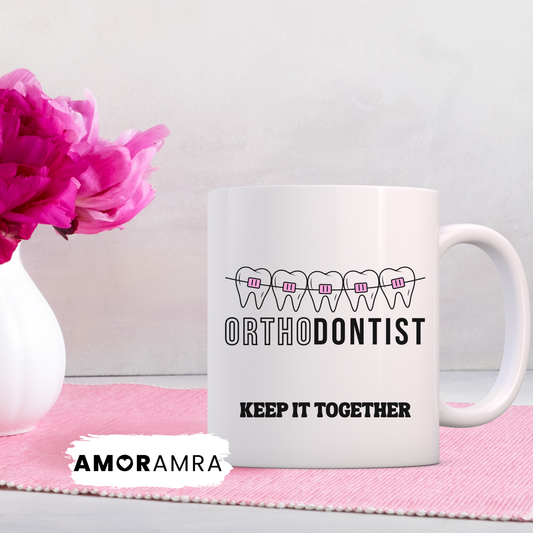 White mug with 'Orthodontist Keep It Together' with pink braces design